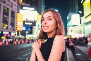 Young woman tourist takes selfie photo on Times Square, New York, USA